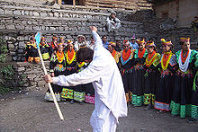 a kalash man dances during the uchau festival.